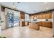 Kitchen with light wood cabinets, island, and sliding door to backyard at 6901 Copper Kettle Ave, Las Vegas, NV 89130