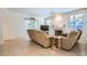 Bright living room with tile floors, fireplace, and two recliner sofas at 6901 Copper Kettle Ave, Las Vegas, NV 89130