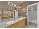 Double vanity bathroom with granite countertop and shower at 6948 Emerald Springs Ln, Las Vegas, NV 89113