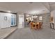 Open concept dining room with kitchen view and stone wall at 6948 Emerald Springs Ln, Las Vegas, NV 89113