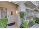 Front entrance with white door, sidelights, and potted plants at 6948 Emerald Springs Ln, Las Vegas, NV 89113