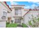 Front view of house with balcony, and nicely landscaped area at 6948 Emerald Springs Ln, Las Vegas, NV 89113