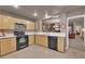 Modern kitchen with light wood cabinets and quartz countertops at 6948 Emerald Springs Ln, Las Vegas, NV 89113