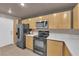 Modern kitchen with light wood cabinets and quartz countertops at 6948 Emerald Springs Ln, Las Vegas, NV 89113