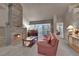 Living area with stone fireplace, piano, and large windows at 6948 Emerald Springs Ln, Las Vegas, NV 89113