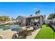 Relaxing poolside patio with fire pit and built-in seating at 7026 Westpark Ct, Las Vegas, NV 89147