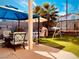 Backyard with patio furniture, playset, and artificial turf at 7629 Delaware Bay Dr, Las Vegas, NV 89128