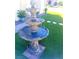 Three-tiered fountain in a front yard with artificial turf at 7629 Delaware Bay Dr, Las Vegas, NV 89128