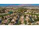 Aerial view of a residential community with houses, streets, and a golf course at 7732 Tinted Mesa Ct, Las Vegas, NV 89149