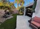 Landscaped backyard with artificial turf and water feature at 7732 Tinted Mesa Ct, Las Vegas, NV 89149