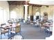 Restaurant-style dining area with stone walls and plenty of tables and chairs at 7732 Tinted Mesa Ct, Las Vegas, NV 89149