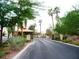 Gated entrance to a community with lush landscaping at 7732 Tinted Mesa Ct, Las Vegas, NV 89149