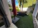 Hot tub area with artificial turf and a red umbrella at 7732 Tinted Mesa Ct, Las Vegas, NV 89149