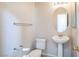 Convenient half bathroom with pedestal sink and toilet at 7809 Smokerise Ct, Las Vegas, NV 89131