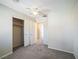 Bedroom with ceiling fan, carpeting, and double closet at 7809 Smokerise Ct, Las Vegas, NV 89131