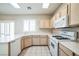 Kitchen with light wood cabinets and white appliances at 7809 Smokerise Ct, Las Vegas, NV 89131