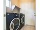 Laundry room with washer, dryer, and shelving at 7809 Smokerise Ct, Las Vegas, NV 89131