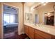 Bright bathroom with double sinks, a walk-in shower, and access to a bedroom at 79 E Agate Ave # 306, Las Vegas, NV 89123