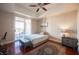 Bedroom with hardwood floors, ceiling fan, and private balcony at 79 E Agate Ave # 306, Las Vegas, NV 89123