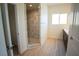 Bright bathroom featuring a walk-in shower, a dark vanity, and modern fixtures at 801 Fort Churchill Rd, Pahrump, NV 89060