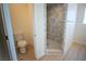 Modern bathroom featuring a walk-in shower, a toilet, and a light wood floor at 801 Fort Churchill Rd, Pahrump, NV 89060