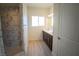 Bright bathroom with walk-in shower, dark vanity, double sinks, and updated fixtures at 801 Fort Churchill Rd, Pahrump, NV 89060