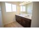 Well-lit bathroom with a dark vanity featuring double sinks and modern fixtures at 801 Fort Churchill Rd, Pahrump, NV 89060