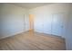 Spacious bedroom featuring neutral walls and light wood-look flooring and double door closet at 801 Fort Churchill Rd, Pahrump, NV 89060