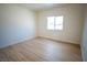 Bedroom with light-colored walls, light-colored wood-look floors and a window with a view of the front yard at 801 Fort Churchill Rd, Pahrump, NV 89060