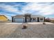 Inviting single-story home showcasing a two-car garage and drought-tolerant desert landscaping at 801 Fort Churchill Rd, Pahrump, NV 89060