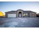 New single-story home with attached garage and arched entryway at 801 Fort Churchill Rd, Pahrump, NV 89060