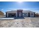 Charming single-story home featuring a neutral color scheme, an attached garage, and contemporary architectural details at 801 Fort Churchill Rd, Pahrump, NV 89060