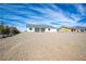 Charming single-story home with a desert landscape under a brilliant blue sky with scattered clouds at 801 Fort Churchill Rd, Pahrump, NV 89060