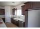 Modern kitchen featuring dark wood cabinetry, stainless steel appliances, and white marble countertops at 801 Fort Churchill Rd, Pahrump, NV 89060