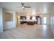 Open-concept kitchen and living area with light wood floors and modern lighting at 801 Fort Churchill Rd, Pahrump, NV 89060