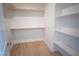 Bright walk-in closet with ample shelving and new light wood flooring at 801 Fort Churchill Rd, Pahrump, NV 89060