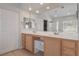 Double vanity bathroom with wood cabinets and mirror at 81 Alpine Bay Ave, Las Vegas, NV 89148