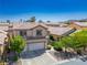 Two-story house with a two-car garage and desert landscaping at 81 Alpine Bay Ave, Las Vegas, NV 89148