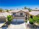 Two-story house with a three-car garage and mature trees at 81 Alpine Bay Ave, Las Vegas, NV 89148