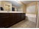 Primary bathroom with double vanity, soaking tub and tile floor at 8384 Creek Canyon Ave, Las Vegas, NV 89113