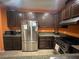 Modern kitchen with dark wood cabinets, stainless steel appliances, and granite countertops at 8384 Creek Canyon Ave, Las Vegas, NV 89113