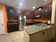 Modern kitchen with dark cabinets and granite countertops at 8384 Creek Canyon Ave, Las Vegas, NV 89113