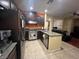 Modern kitchen with dark cabinets and granite countertops at 8384 Creek Canyon Ave, Las Vegas, NV 89113