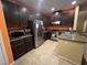 Modern kitchen with dark cabinets and granite countertops at 8384 Creek Canyon Ave, Las Vegas, NV 89113