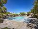 Community swimming pool with lounge chairs and a covered area at 8384 Creek Canyon Ave, Las Vegas, NV 89113