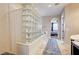 Spa-like bathroom with a glass block shower and soaking tub at 8593 Garden Valley Ct, Las Vegas, NV 89178