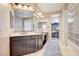 Double vanity bathroom with a large glass block shower at 8593 Garden Valley Ct, Las Vegas, NV 89178