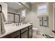 Bathroom with dark brown vanity, a large mirror, and a walk-in shower at 8593 Garden Valley Ct, Las Vegas, NV 89178