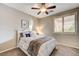 Bedroom with a queen bed, ceiling fan, and window shutters at 8593 Garden Valley Ct, Las Vegas, NV 89178