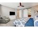 Main bedroom with barn door entry to bathroom and large TV at 8593 Garden Valley Ct, Las Vegas, NV 89178